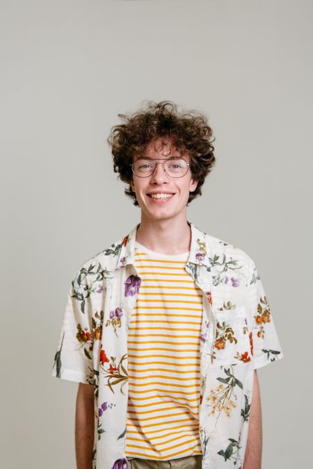 A smiling creator in glasses and a patterned shirt — photo by Pavel Danilyuk on Pexels