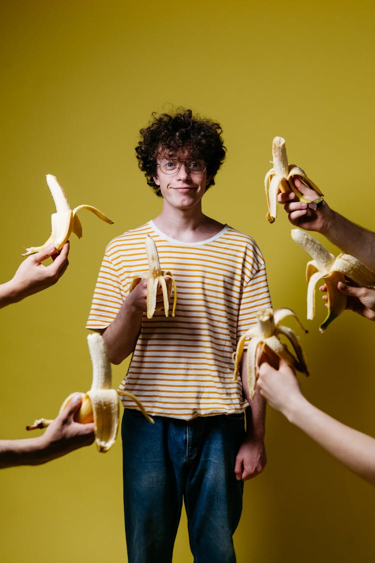 A Man Holding A Banana