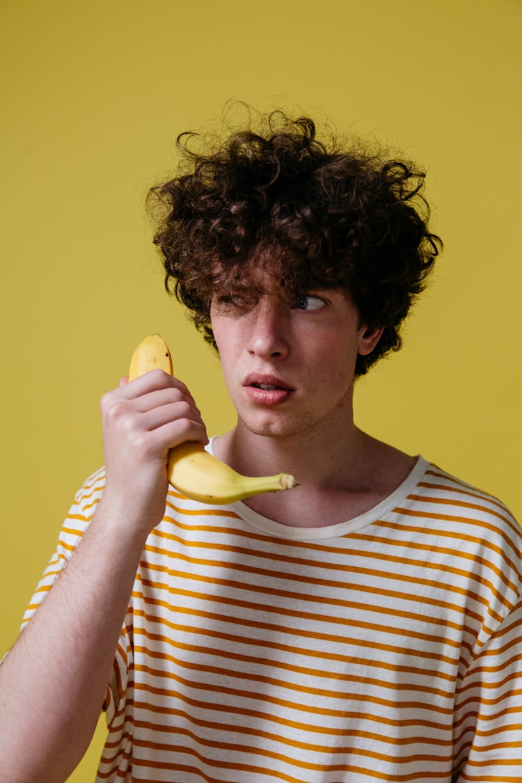 A Man Holding A Banana