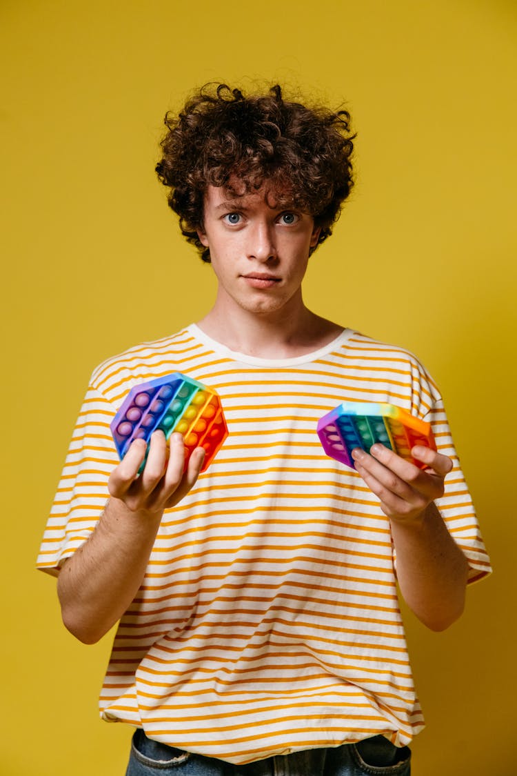 A Man Holding Pop-It Fidget Toys