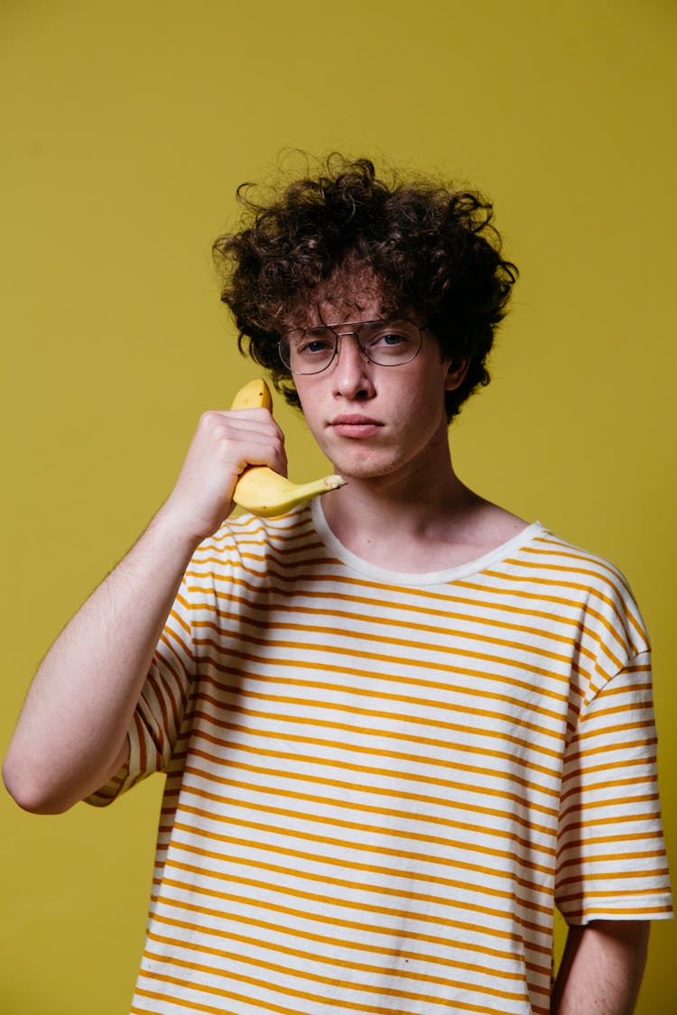 A Man Holding A Banana