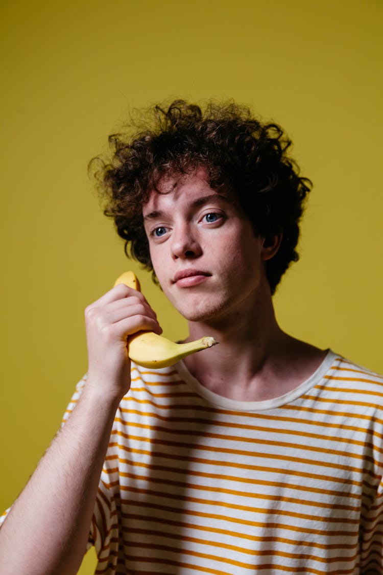 A Man Holding A Banana