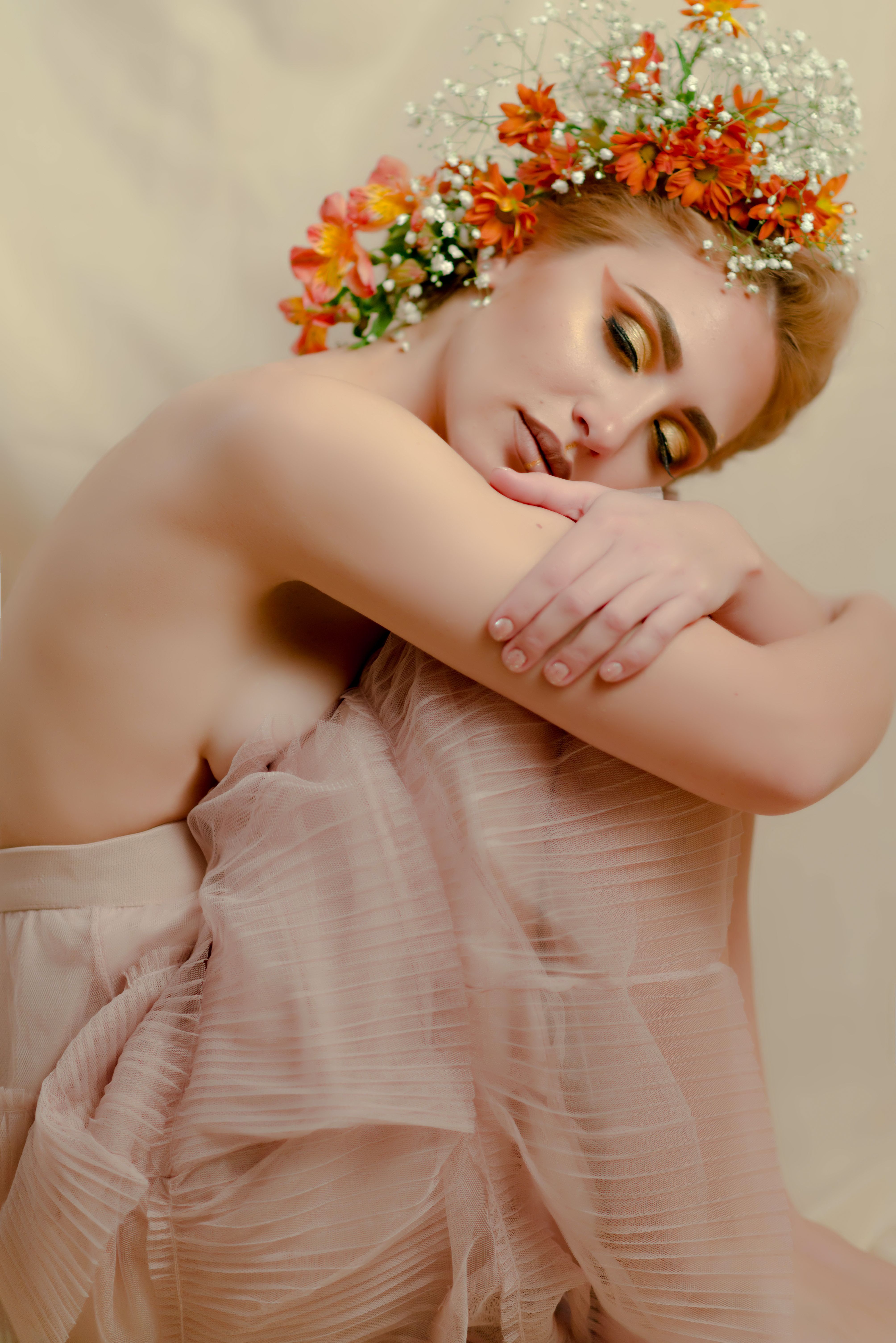 A serene portrait of a woman with vibrant floral headpiece, embodying grace and elegance.
