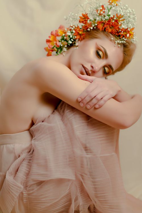 Free A serene portrait of a woman with vibrant floral headpiece, embodying grace and elegance. Stock Photo