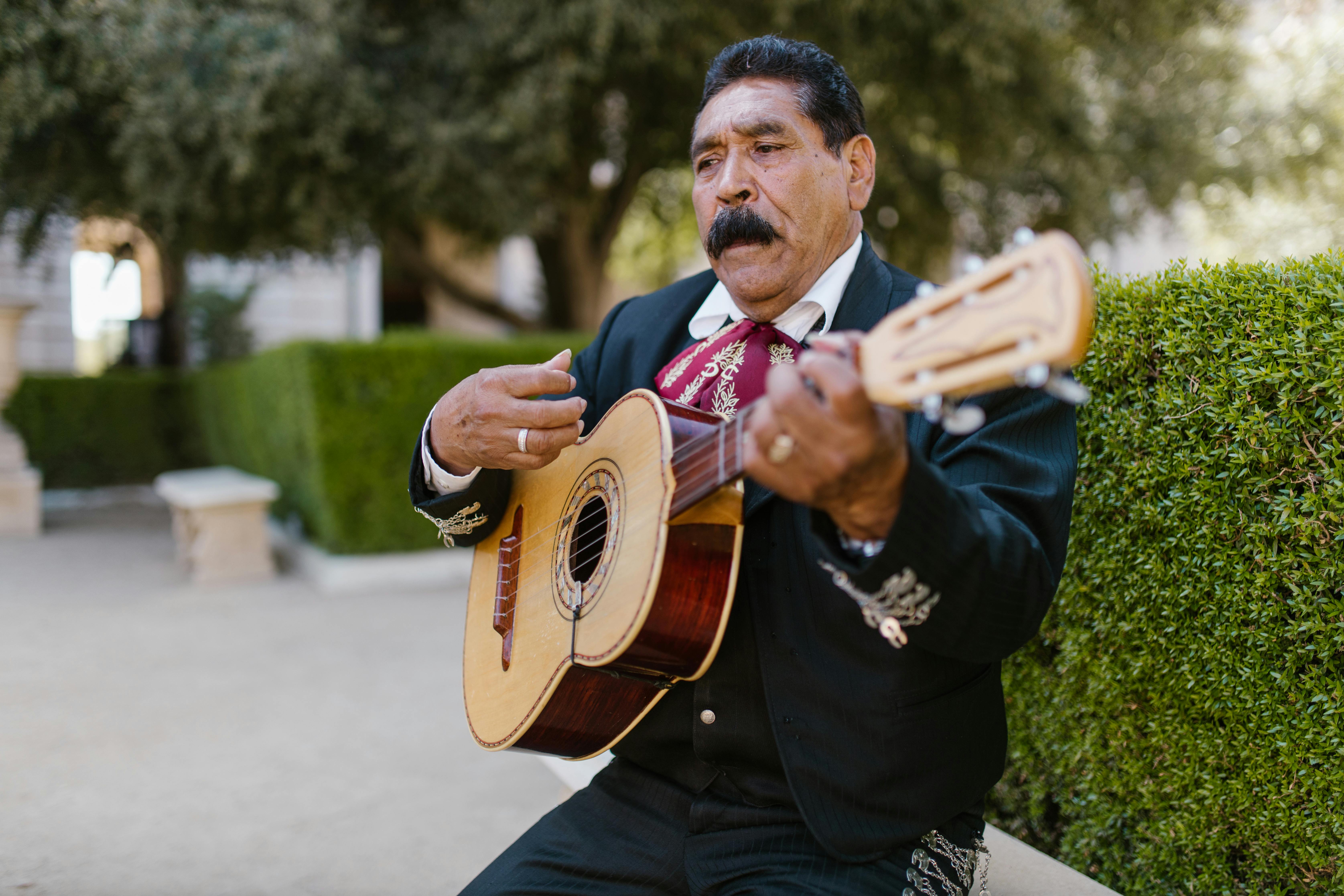 Man in Black Charro Playing Guitar · Free Stock Photo