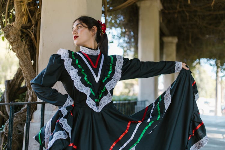 A Woman In Black Dress Dancing