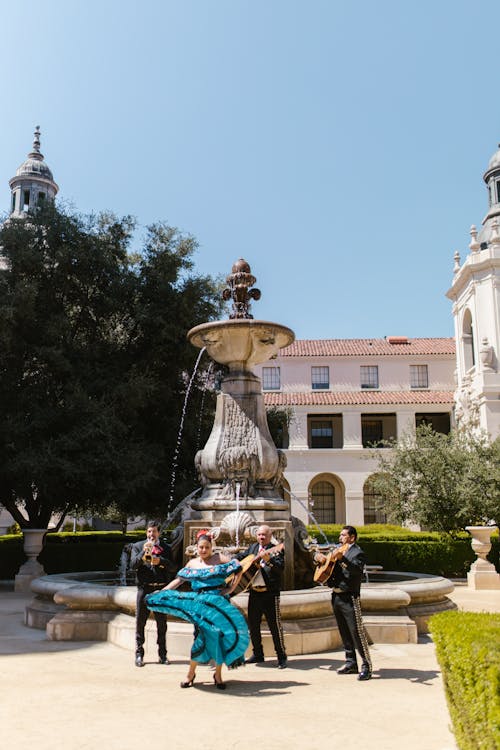 People Sitting on Bench Near Fountain