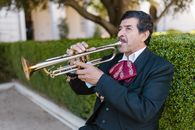 Man in Black Suit Playing Trumpet