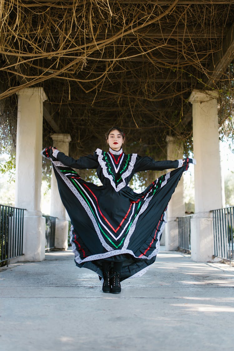 A Woman In Black Dress Dancing