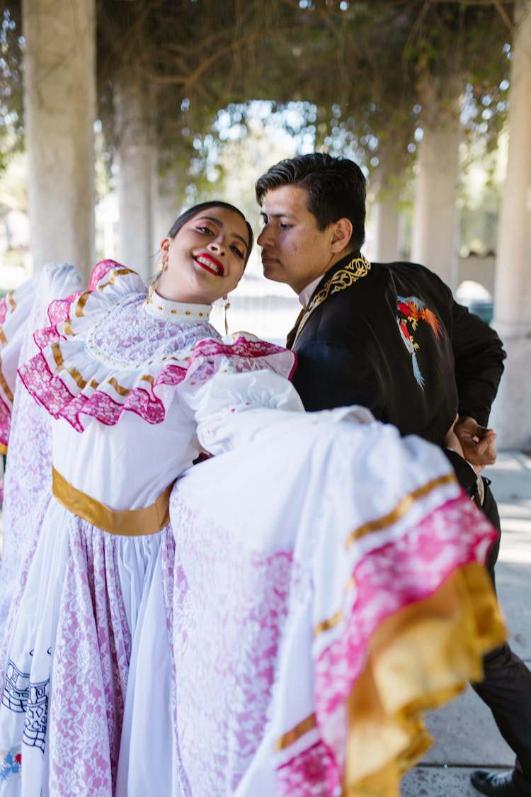 Man And Woman Wearing Traditional Clothes While Dancing