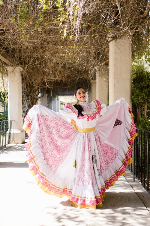 Free Young woman in traditional Mexican dress posing outdoors, exuding cultural charm and elegance. Stock Photo