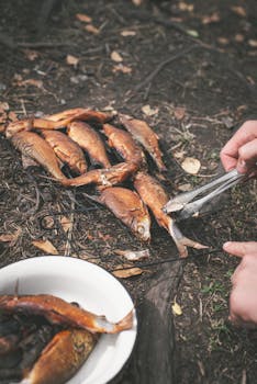 Freshly grilled fish being prepared outdoors in Karelia, Russia's forest.