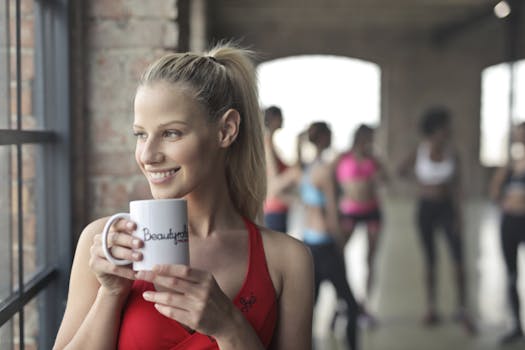 Woman Wearing Red Tank Top Holding White Ceramic Mug 