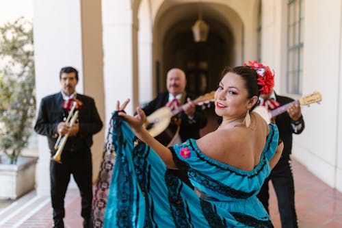 Dancer in Traditional Dress and Musicians behind