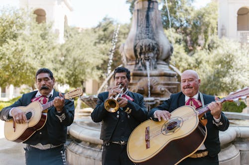 Free Men in Black Suits Playing Musical Instrument Stock Photo