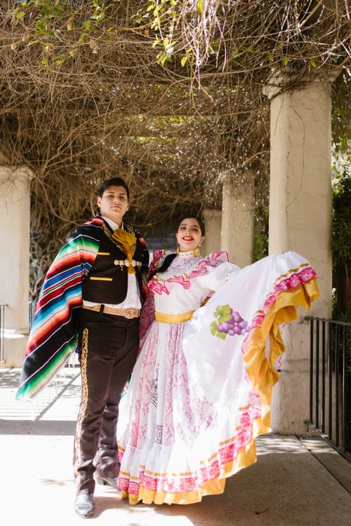 Free A couple poses in colorful traditional Mexican attire outdoors, showcasing vibrant cultural fashion. Stock Photo