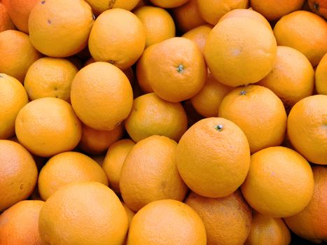 A high-angle view of fresh organic oranges showcasing their vibrant color and texture.