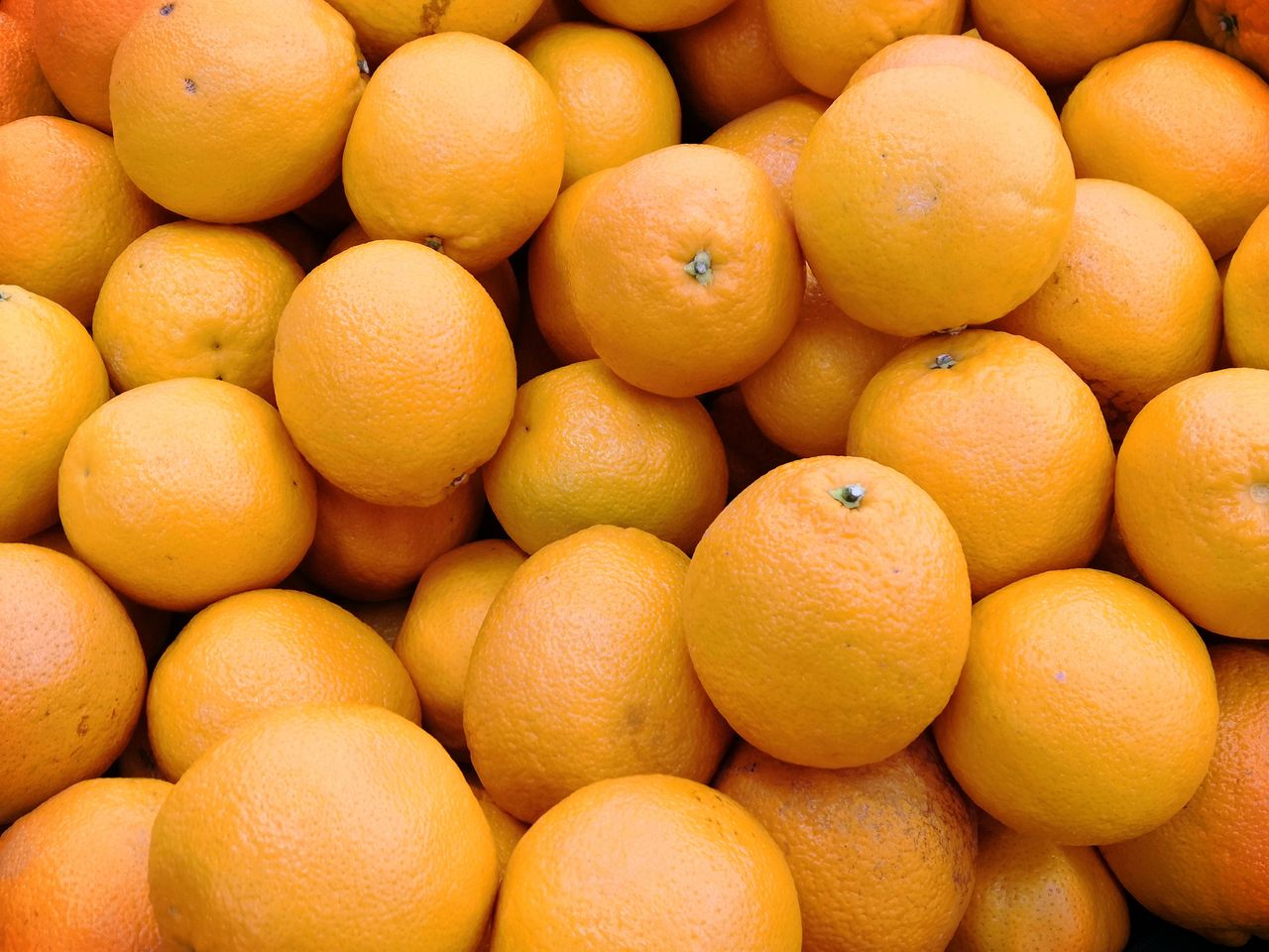 a high angle view of fresh organic oranges showcasing their vibrant co