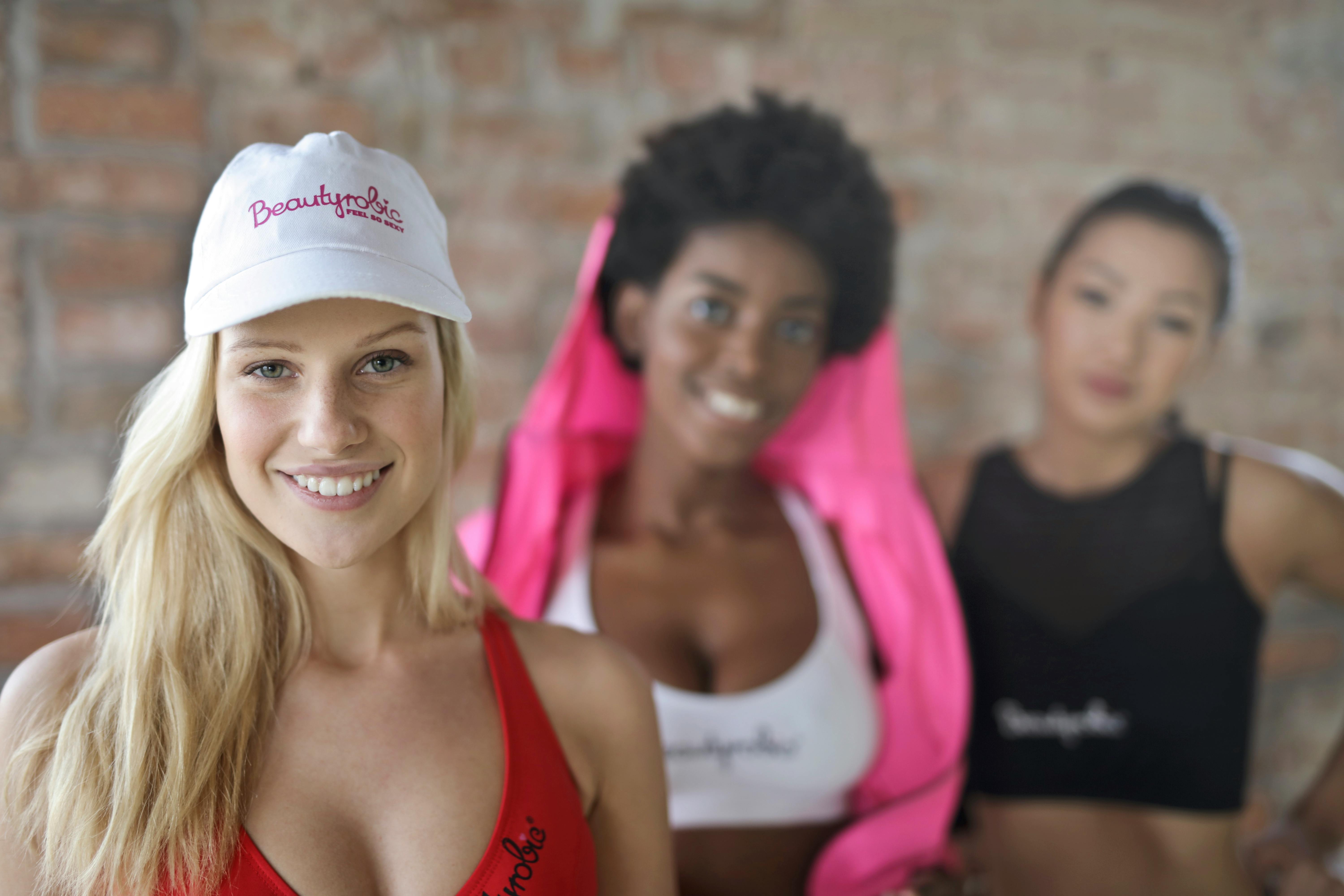 Three Woman Wearing of Red, White, and Black Sport Bras · Free Stock Photo