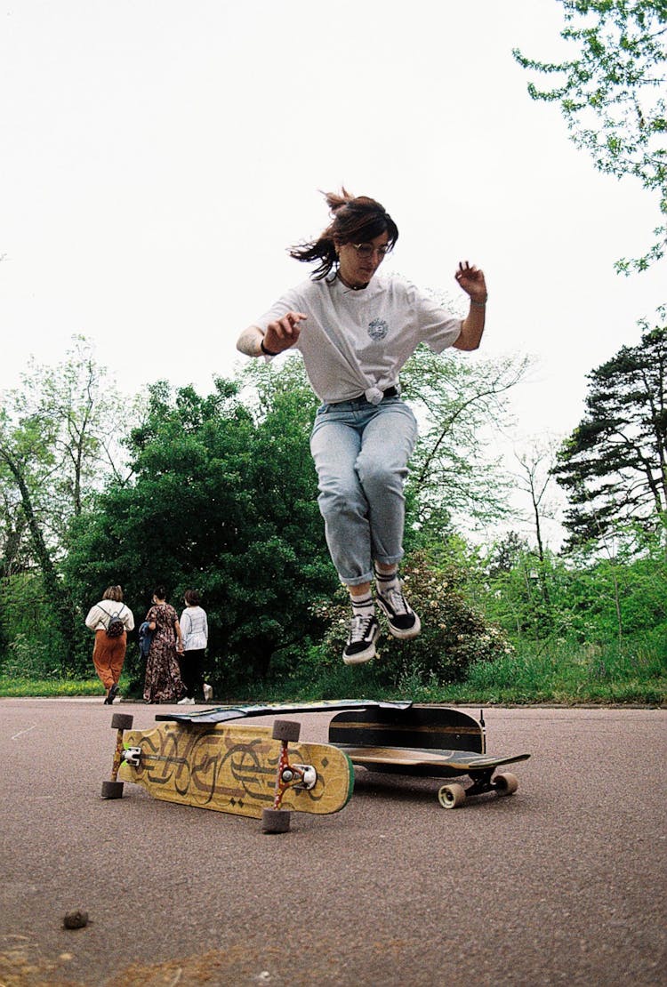 Woman Skateboarding On Concrete Road