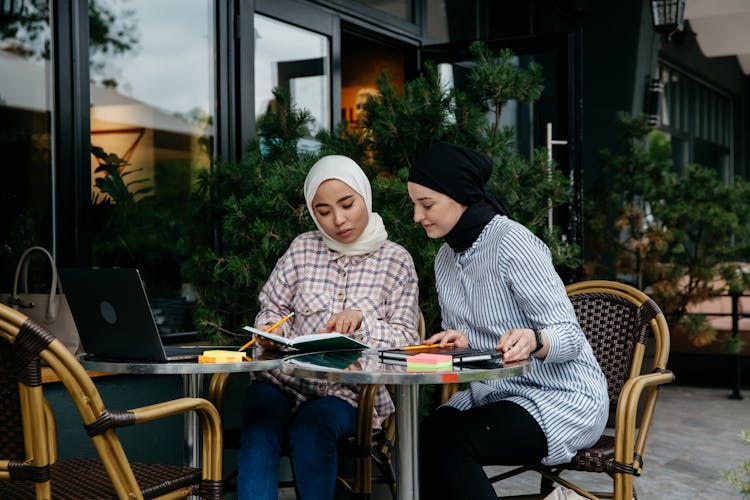 Women Sitting At The Table