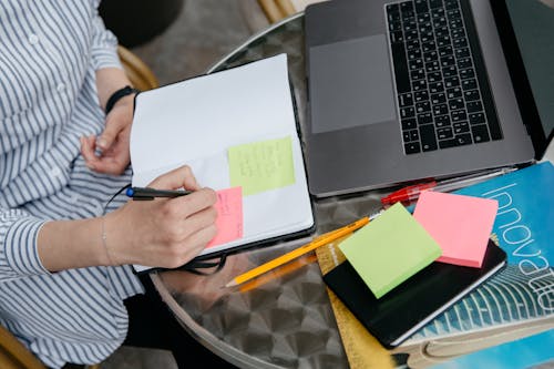 A Person Writing on Sticky Note