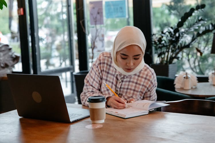 A Woman Writing At The Table