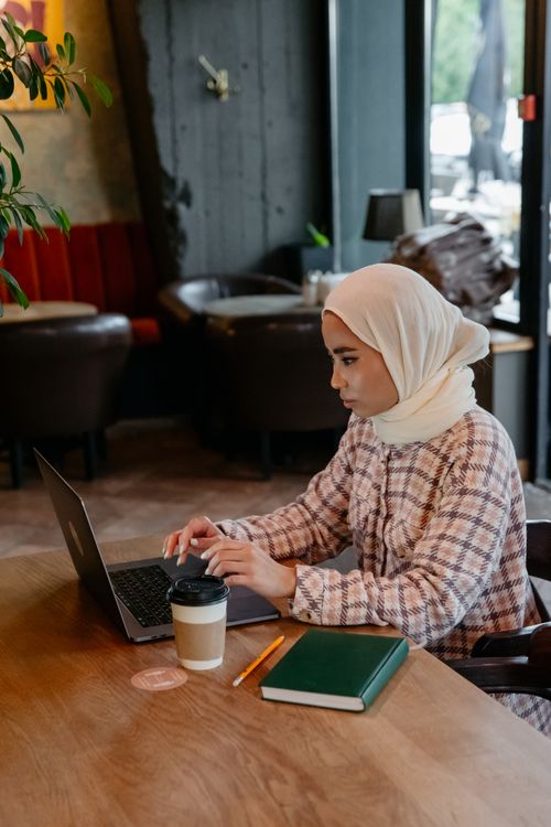 Woman in White Hijab Using Her Laptop · Free Stock Photo