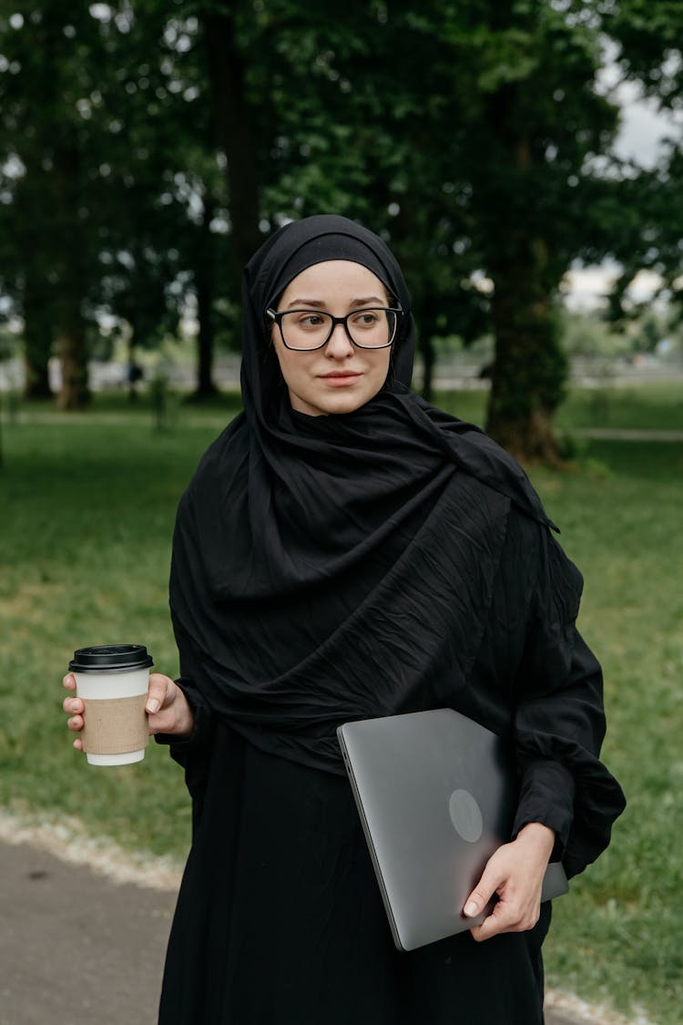 Woman With A Black Hijab Holding A Cup Of Coffee