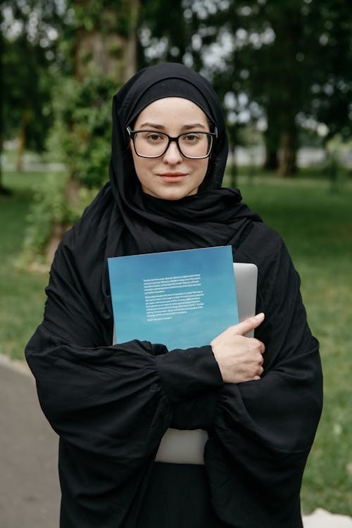 Woman Posing on City Street with Books