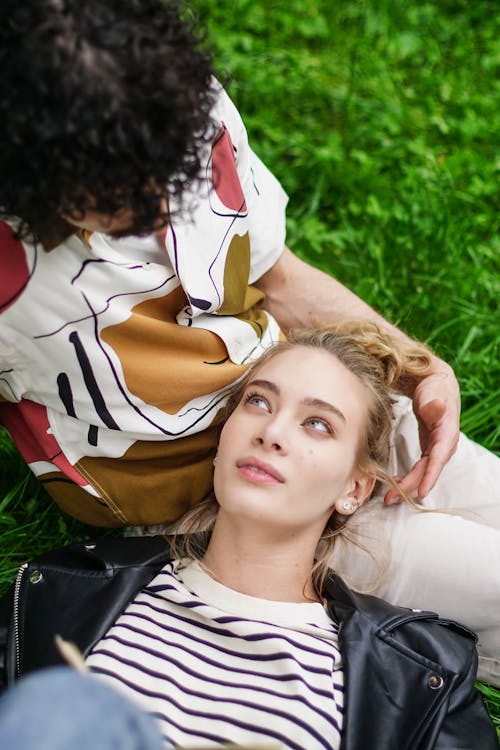 Free Overhead Shot of a Woman Lying on a Person's Lap Stock Photo