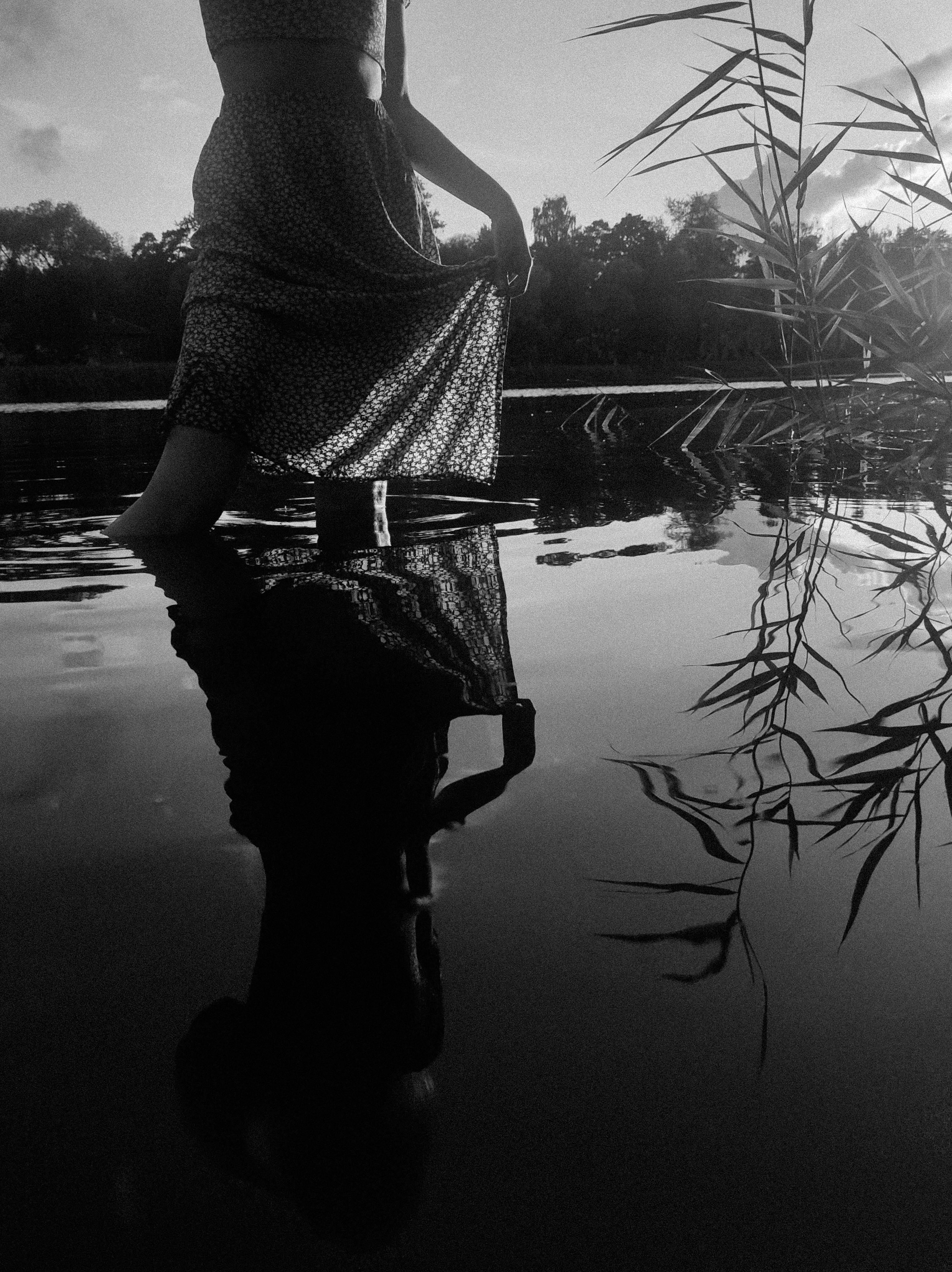 Reflection of Woman in Dress Walking in Water Free Stock Photo