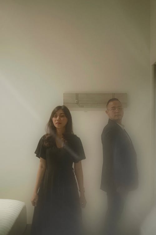 A Man and a Woman Standing inside a Room Together
