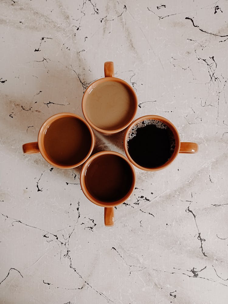 Orange Ceramic Mugs On Table