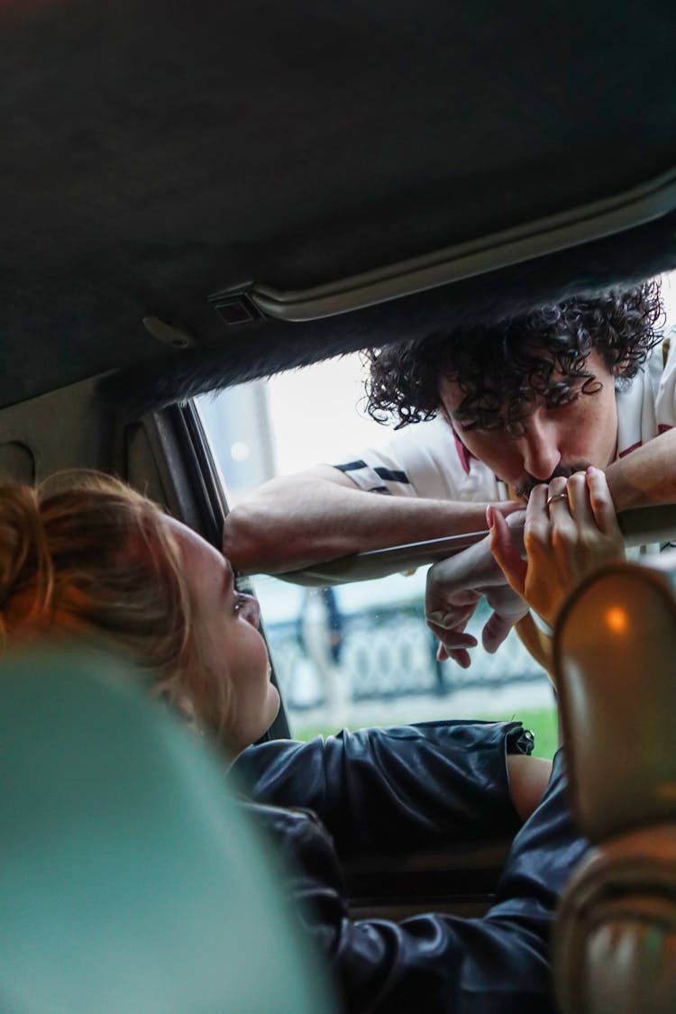 A Couple Talking In The Car Window