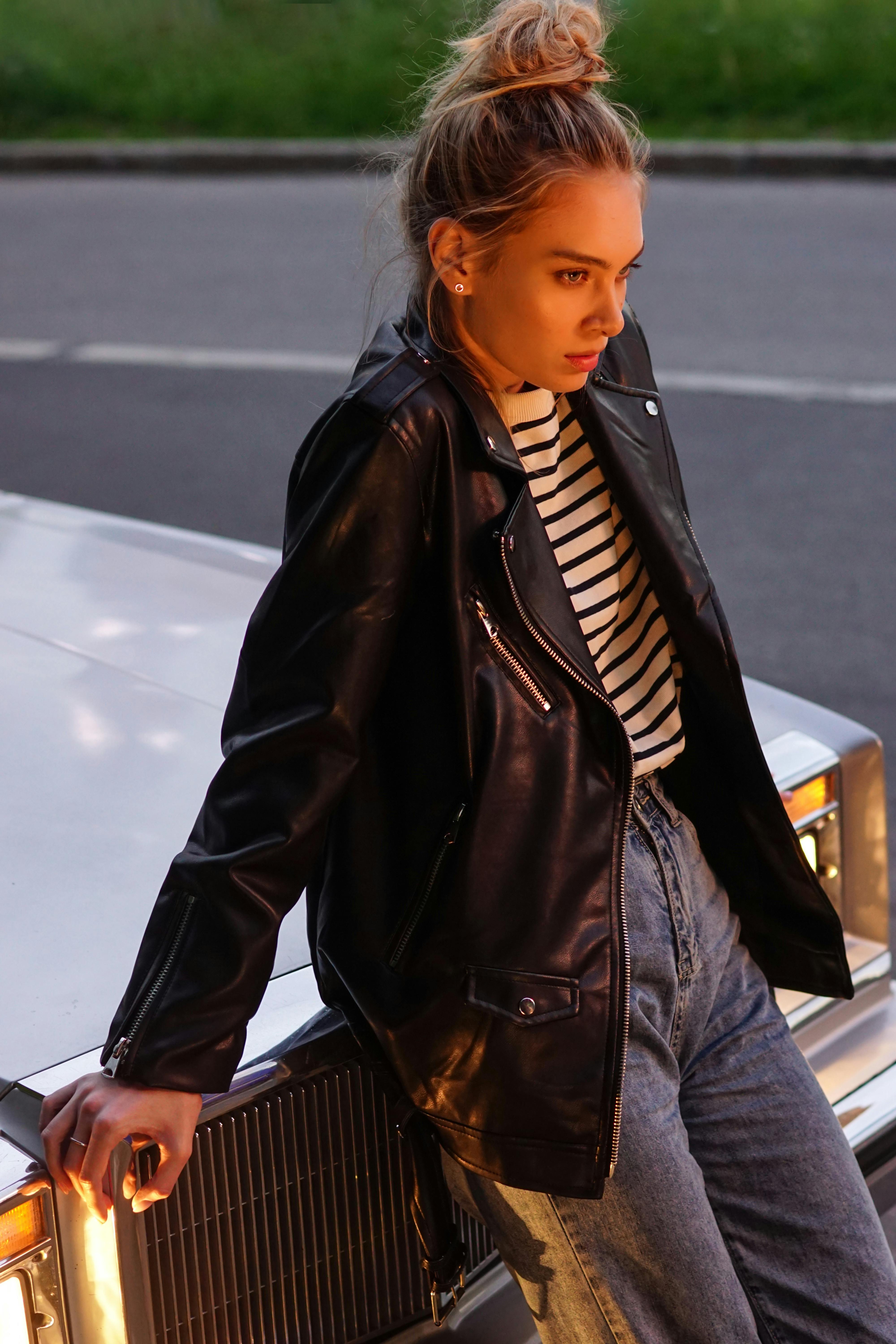 woman wearing a black leather jacket and striped shirt