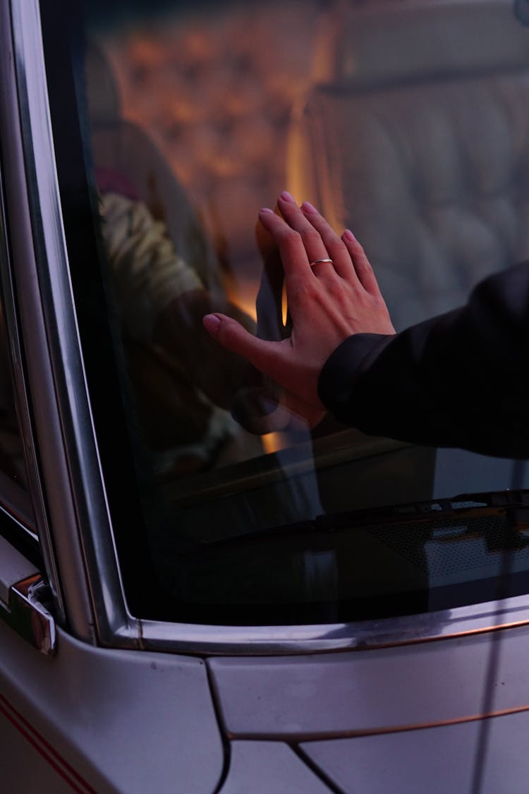 Man And Woman Hands Touching Car Window