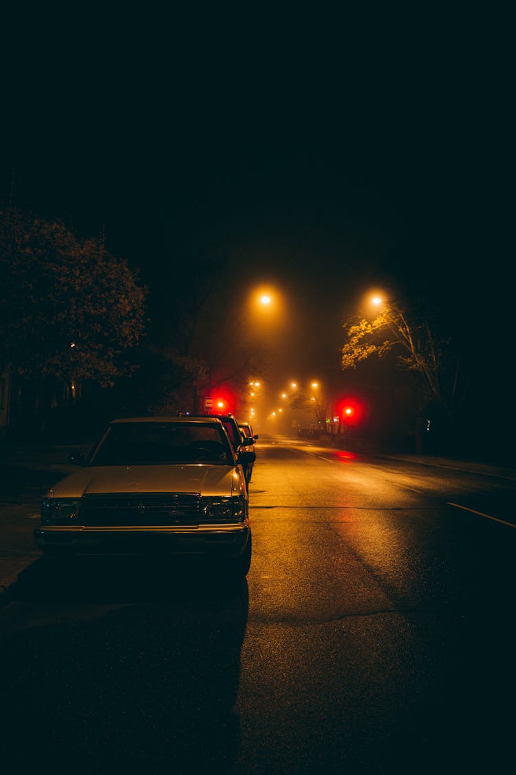 Cars Parked On A Road At Night 