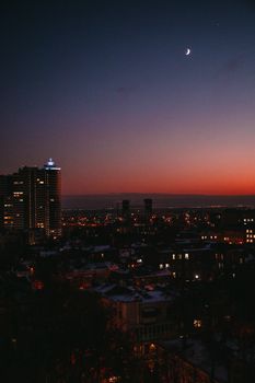 Stunning cityscape at twilight featuring illuminated skyscrapers, creating a beautiful skyline view.