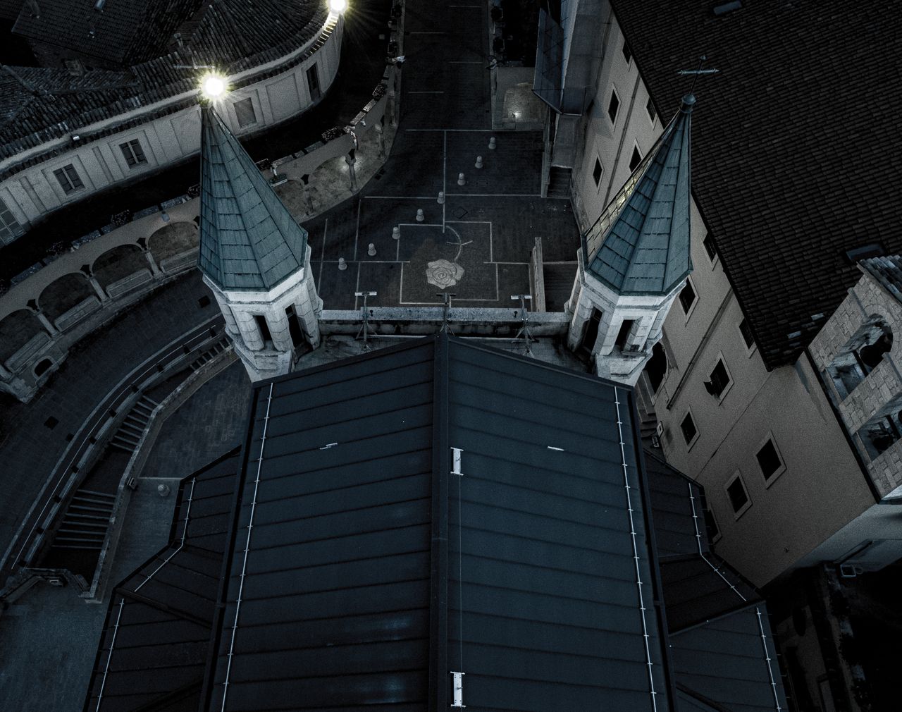 drone shot capturing the rooftops and towers of a historic church from