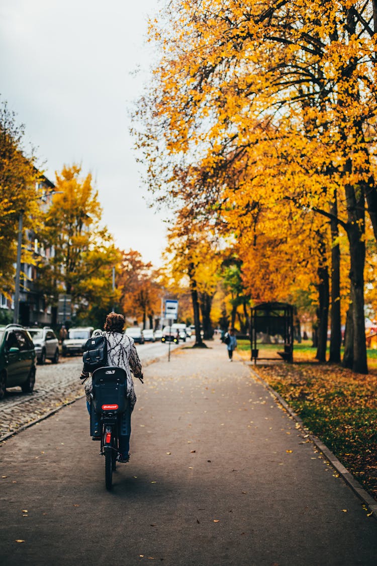 A Person Biking On Sidewalk