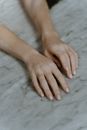 Close-Up of Hands on a Marble Surface