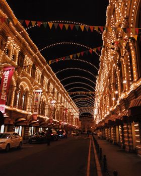 Captivating view of an illuminated Moscow street at night, showcasing vibrant architecture.