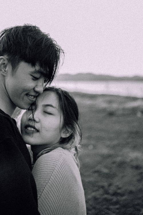 Free Tender grayscale image of a young couple embracing, capturing love and closeness. Stock Photo