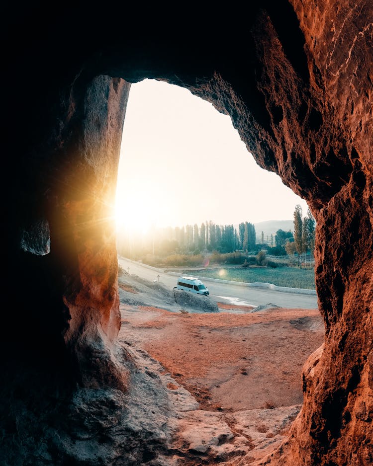 Car Seen Through Hole In Rock