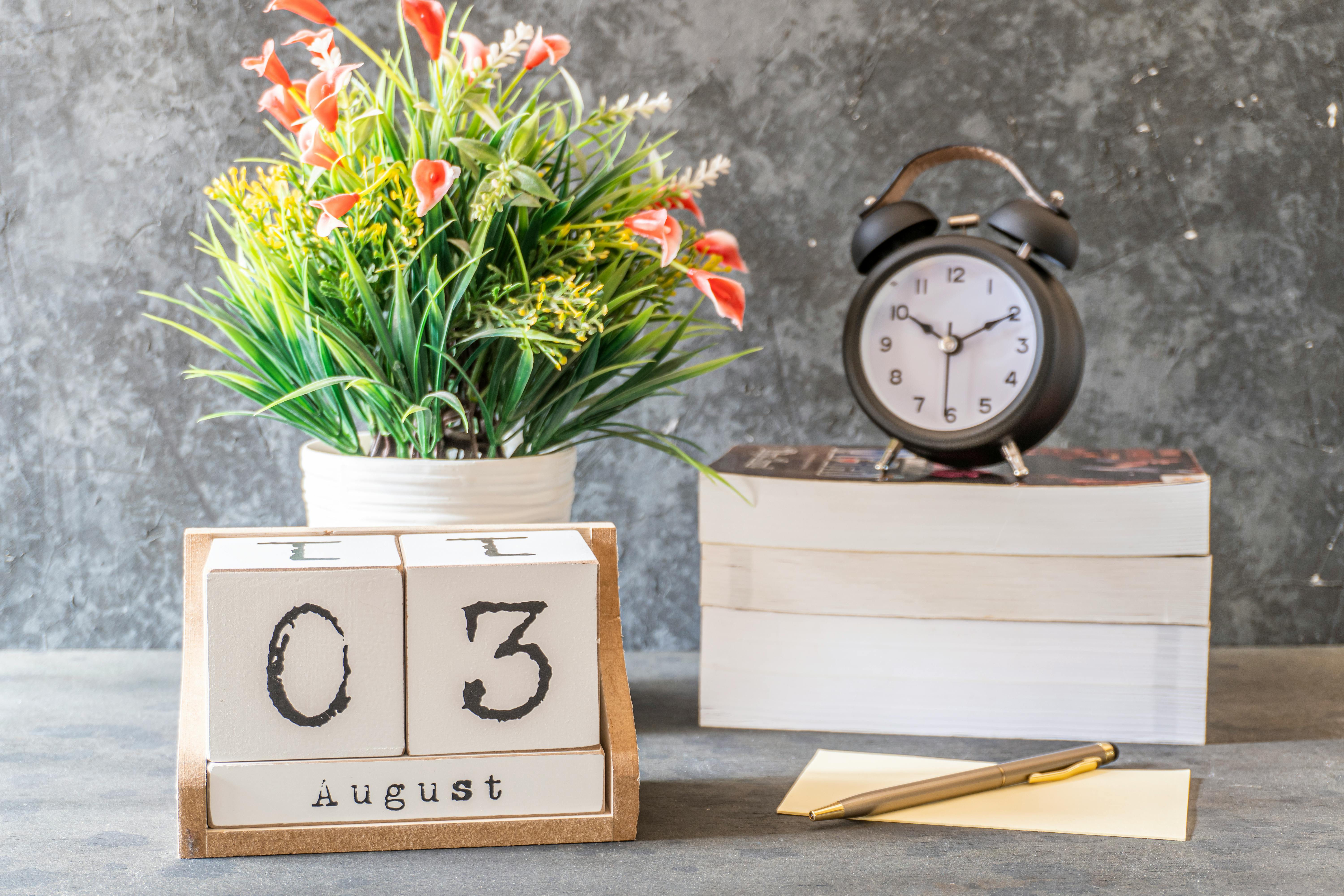 yellow and red flowers on white wooden table