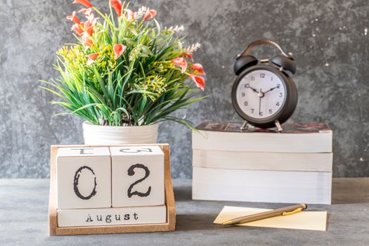 Close-Up Shot of a Black Alarm Clock beside a Calendar