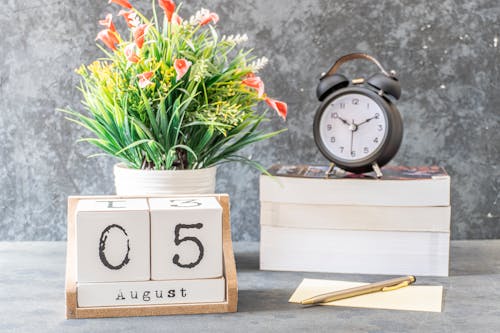 Free Close-Up Shot of a Black Alarm Clock beside a Calendar Stock Photo