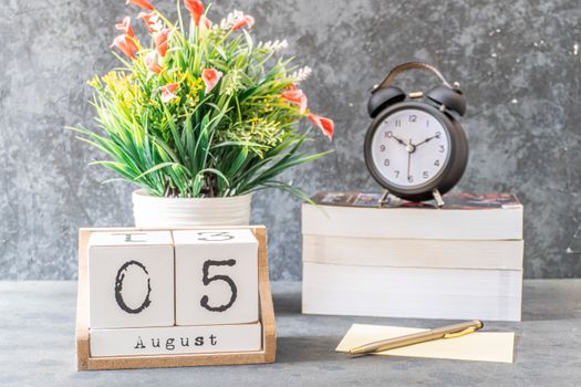 Close-Up Shot of a Black Alarm Clock beside a Calendar