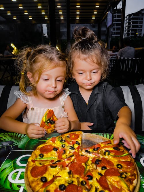 Free 2 Girls Eating Pizza Stock Photo